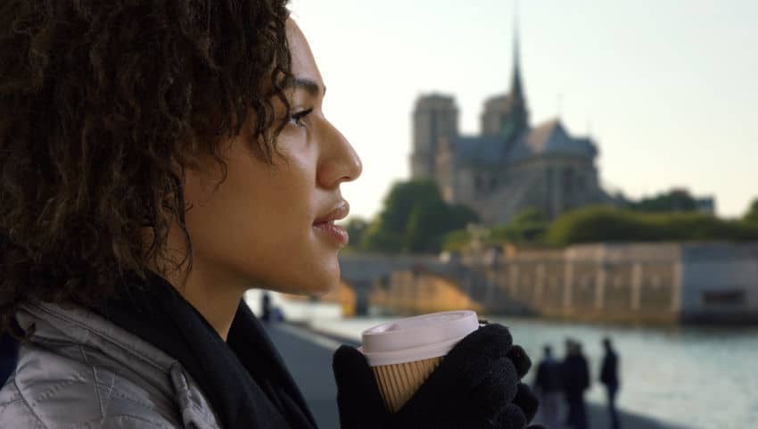 a woman holding a cup of coffee