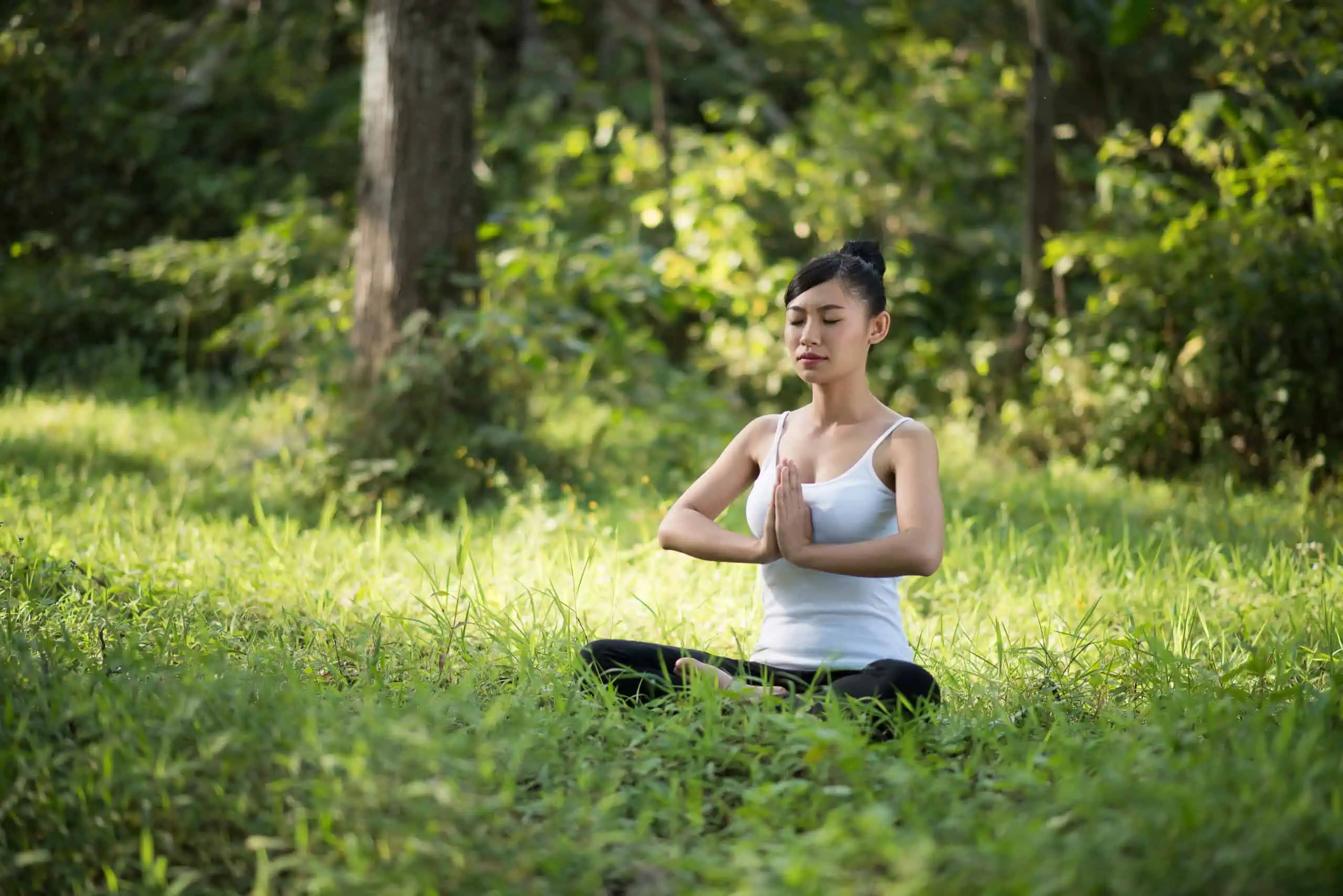 Woman practicing mindful meditation in a calm, quiet setting