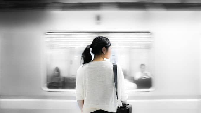 a woman standing in front of a train