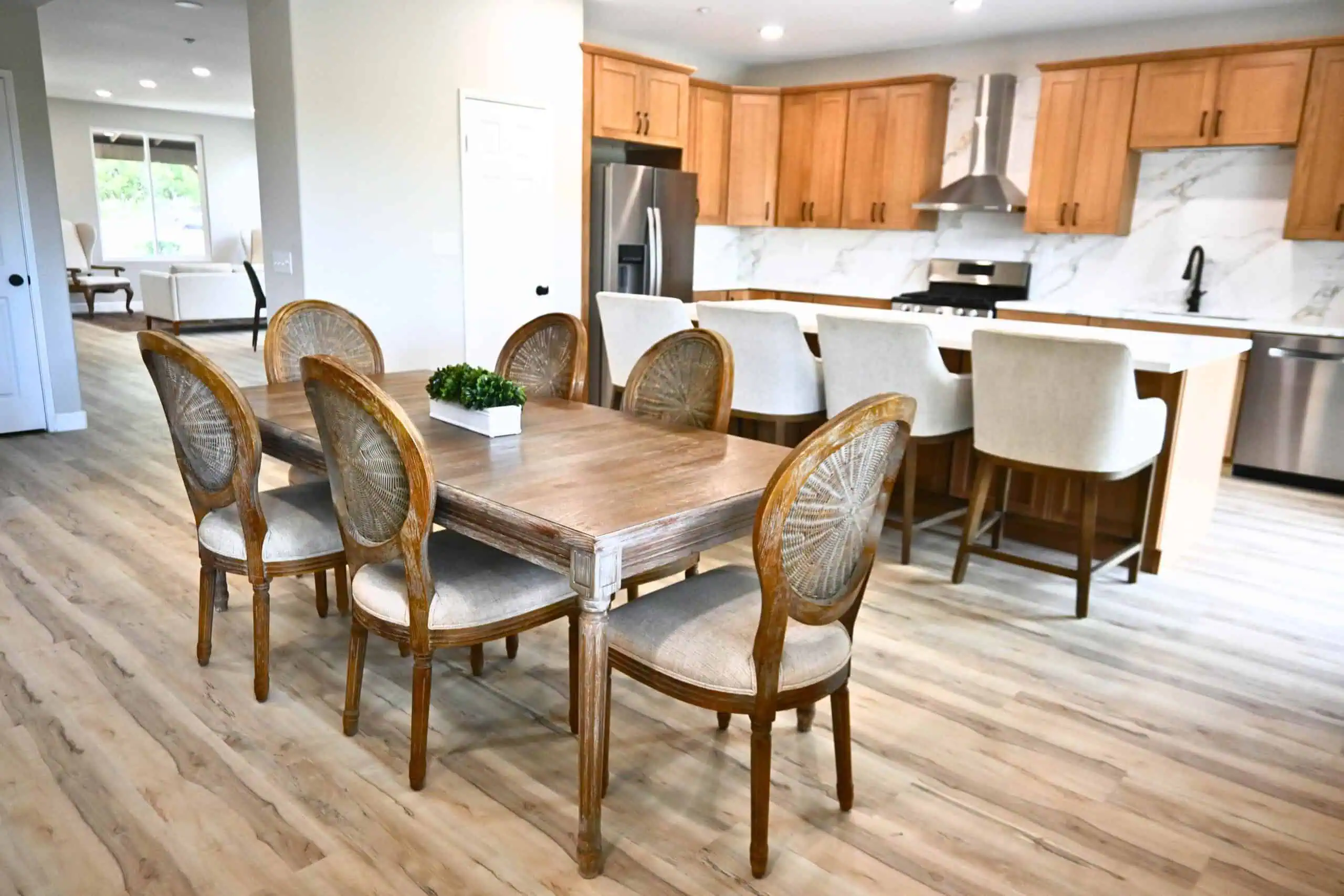 Modern dining area in supportive housing with wooden table and chairs.