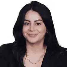 Professional woman with dark hair smiling for a portrait.