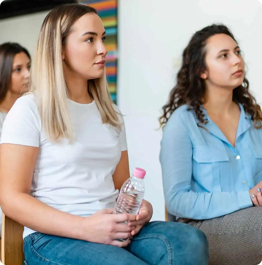 Young women attending a support group session for co-occurring disorders.