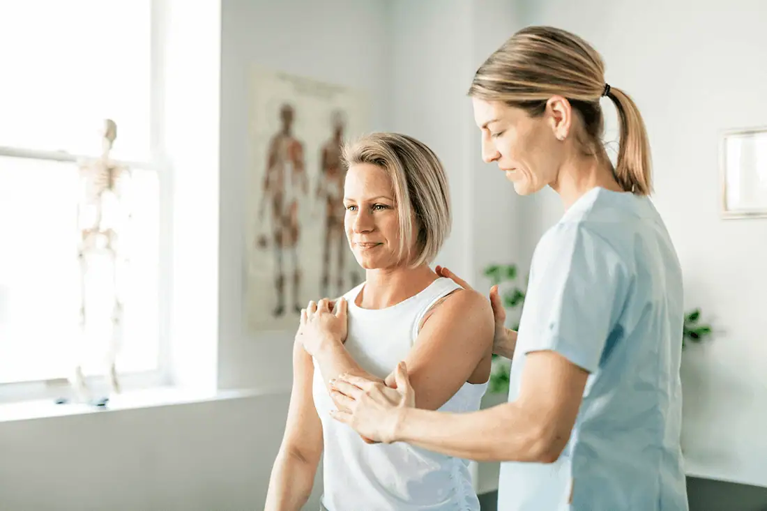 Women receiving shoulder therapy at Sol Womens Treatment clinic in a professional setting.