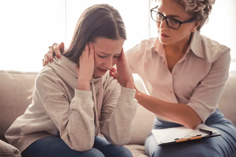 Woman in distress consulting with healthcare professional at Sol Womens Treatment.