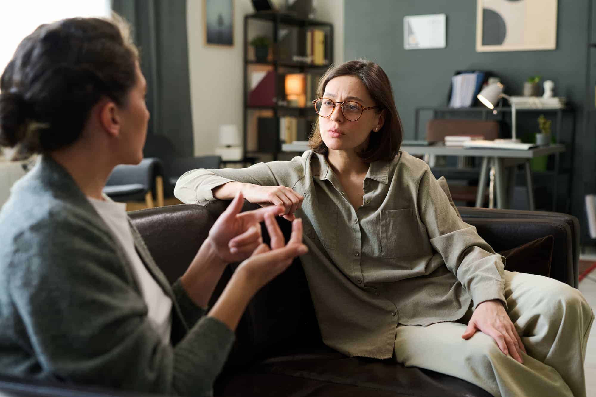 A woman talking with a counselor in a one-to-one therapy session