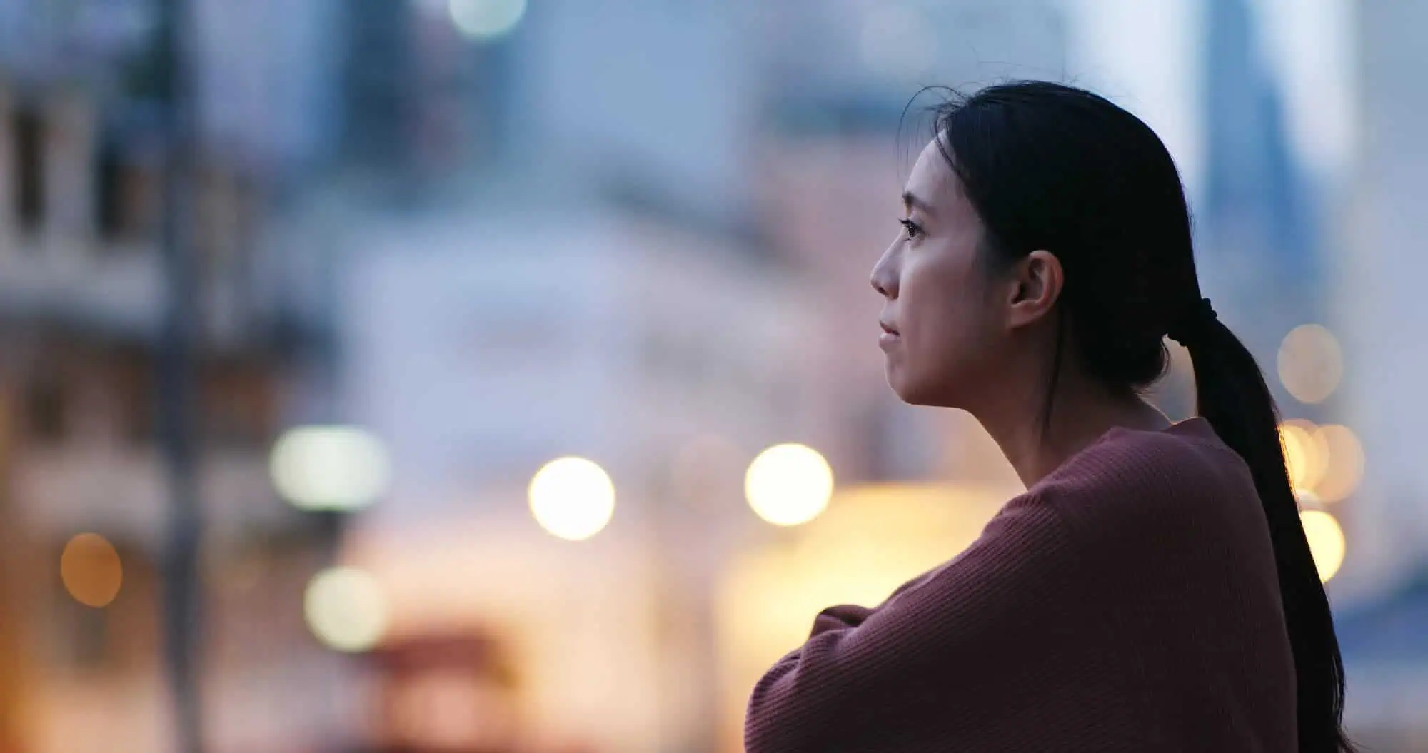 Woman walking and looking around a city street