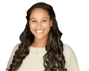 Smiling woman with long curly hair in a professional setting.