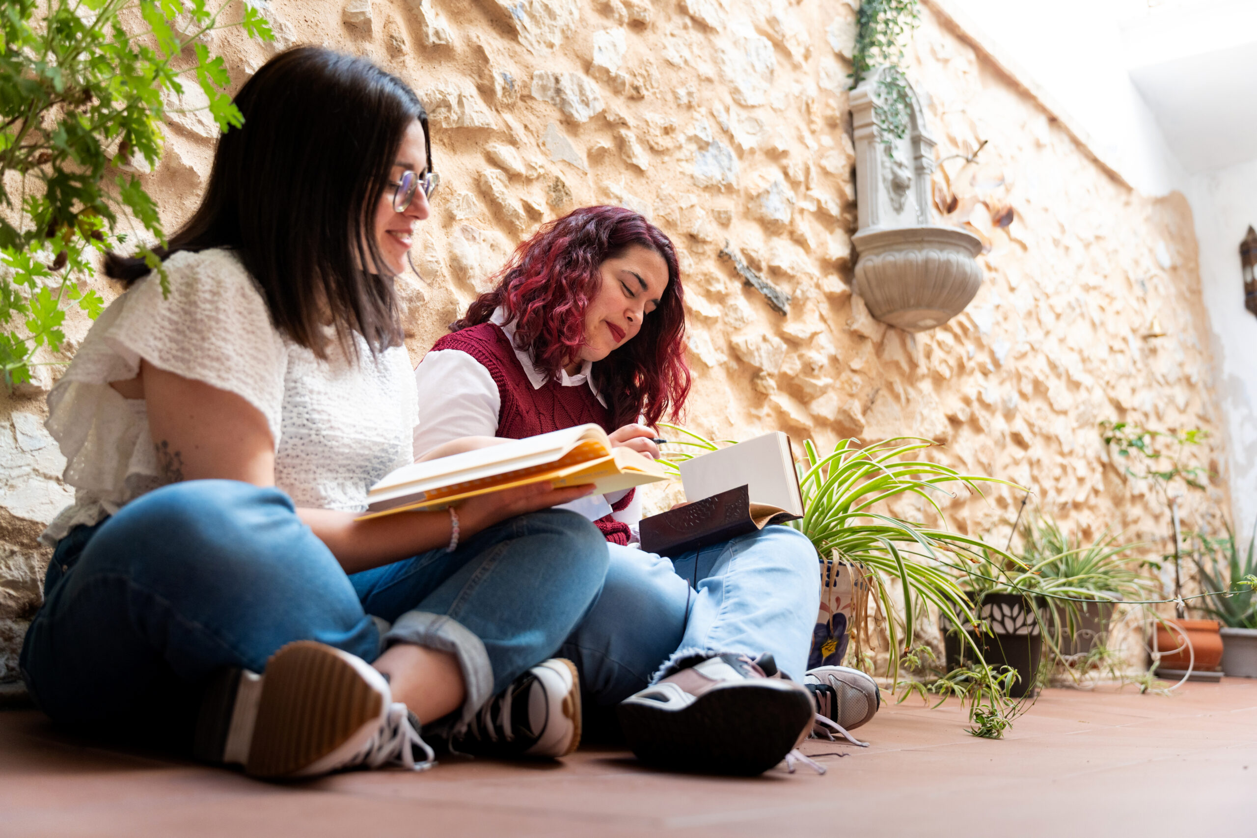 Two women studying together outdoors near UCR campus