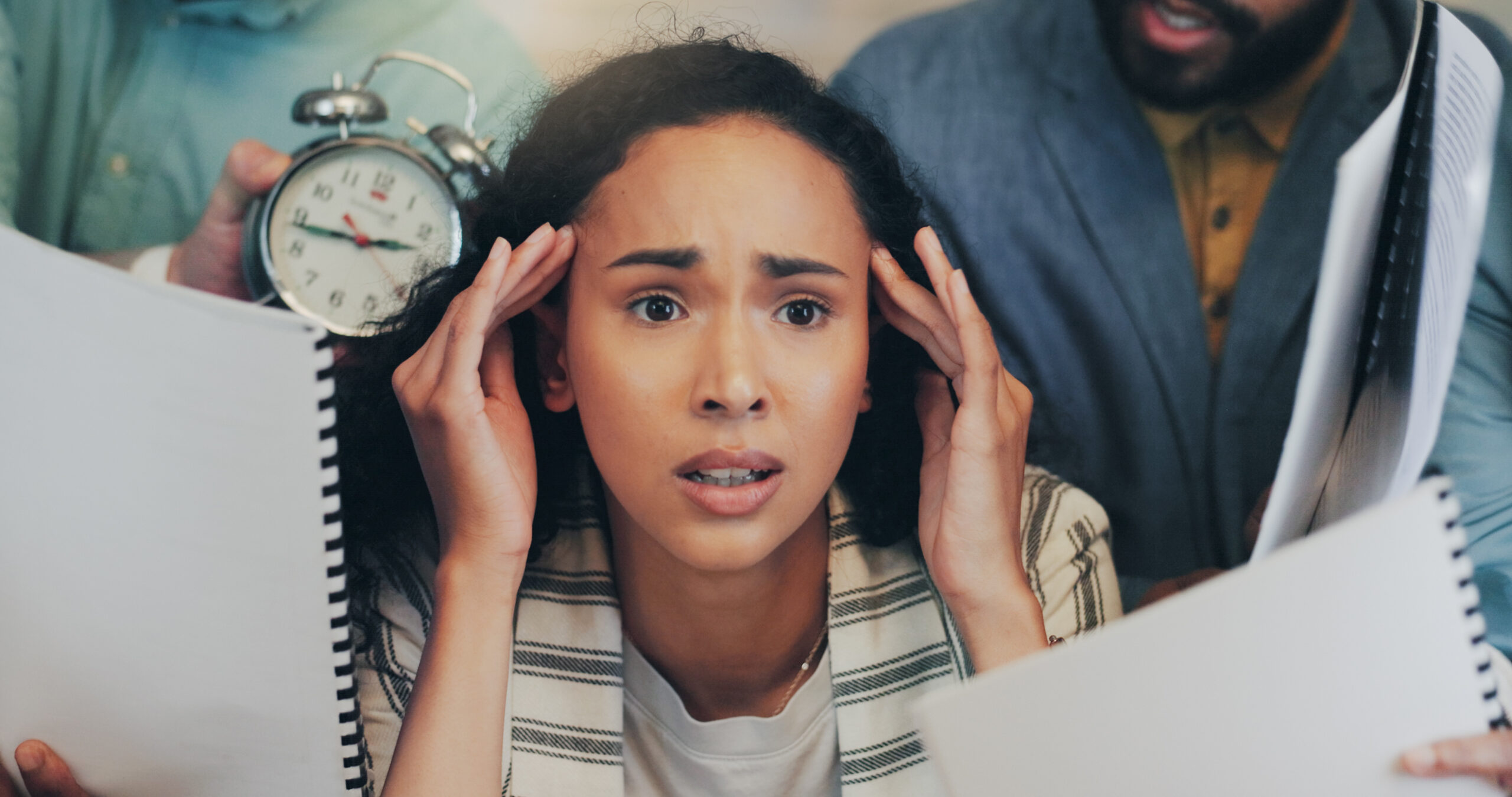 Young woman quietly carrying the weight of work and school stress