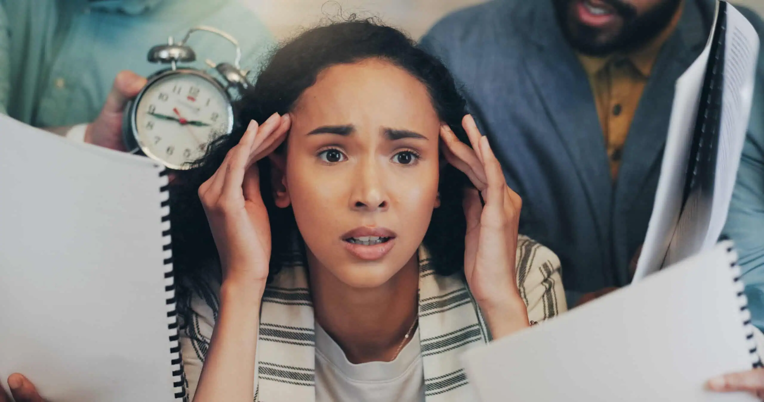Young woman quietly carrying the weight of work and school stress