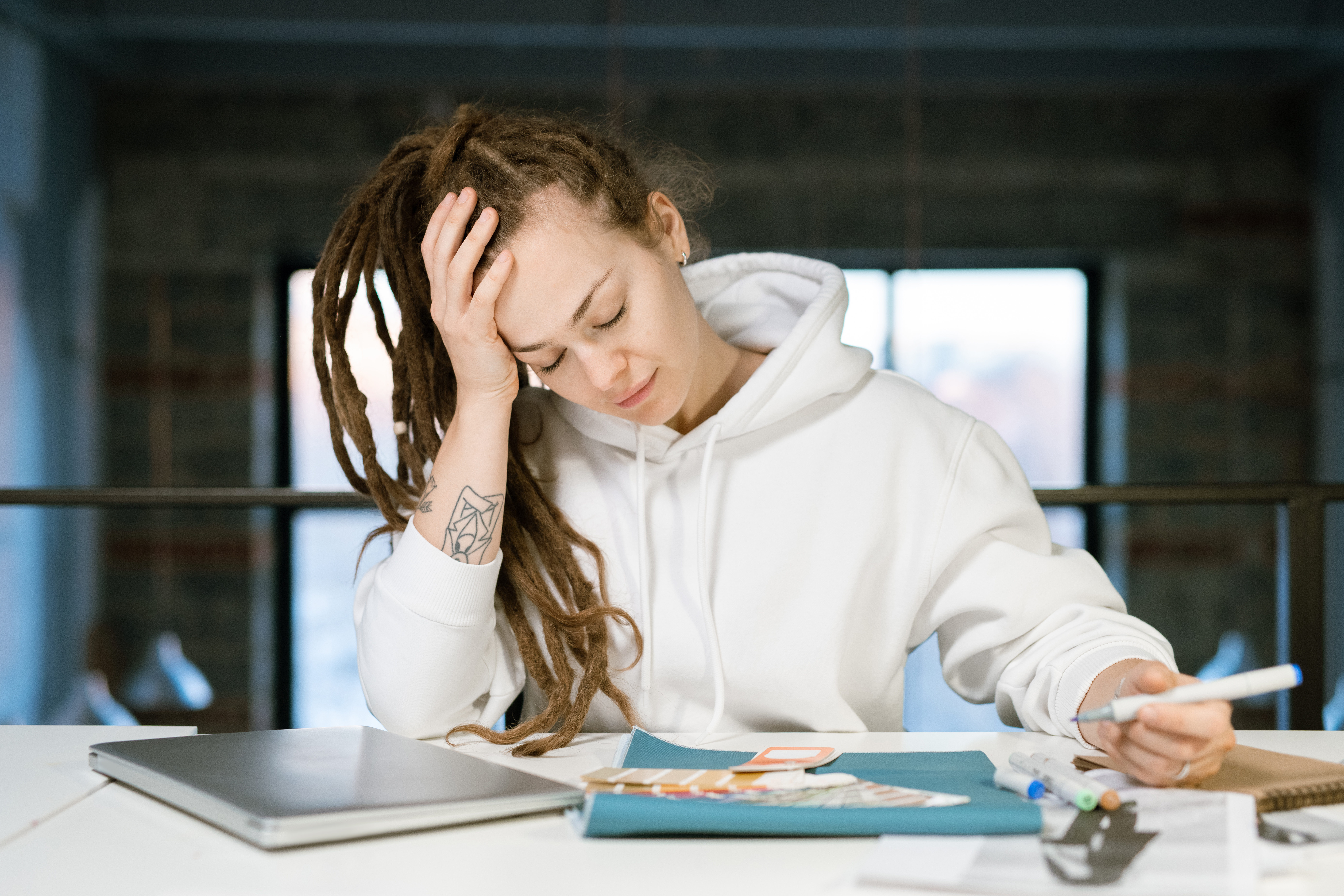College woman studying at her desk under academic pressure