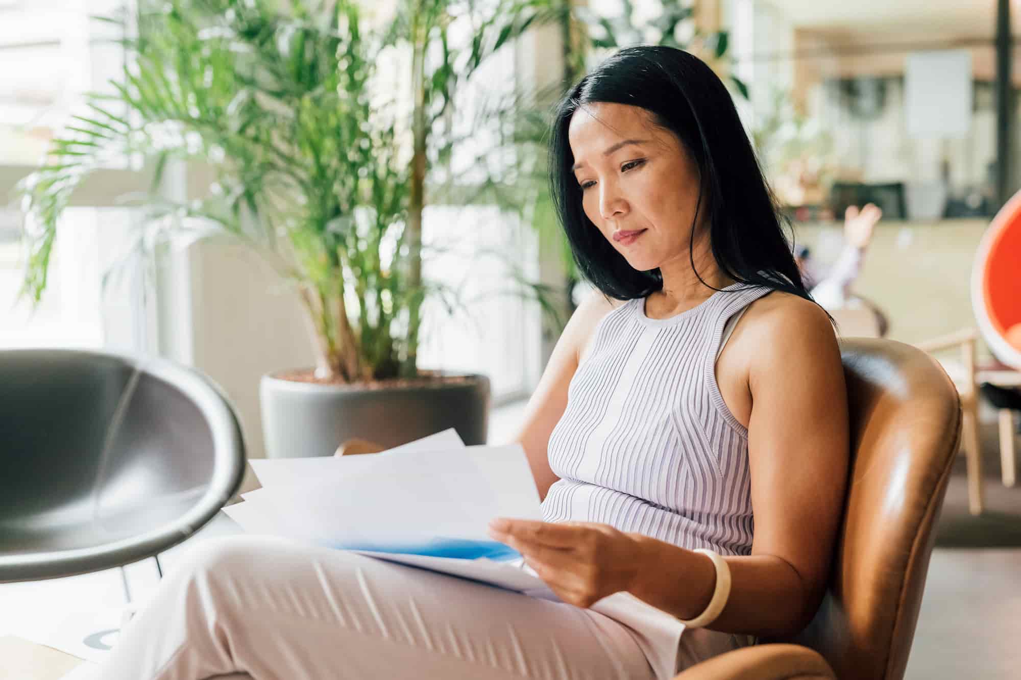 A woman reviewing her HMO coverage details at home