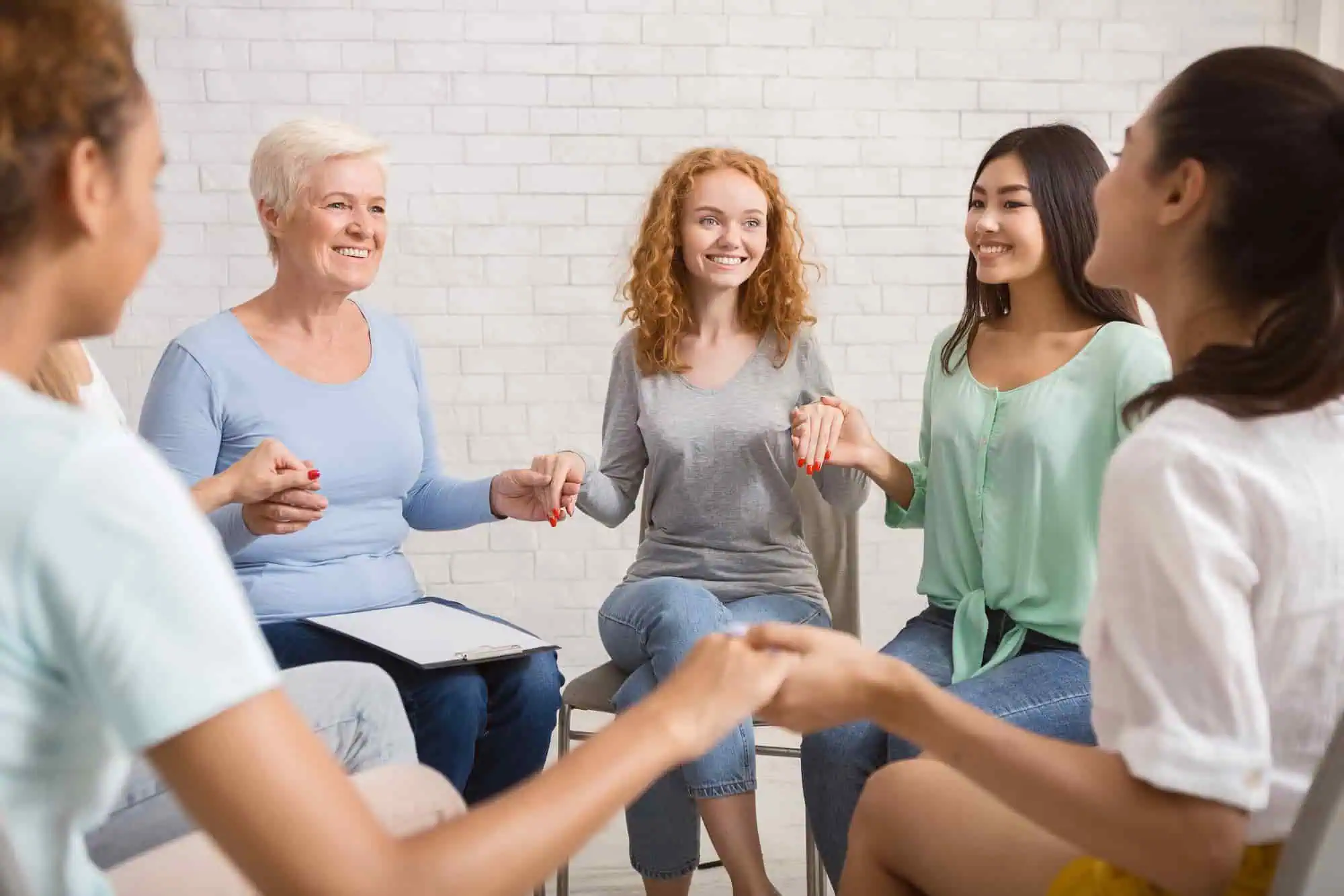 Women sitting together in a circle during a group therapy session at Sol Women's Treatment