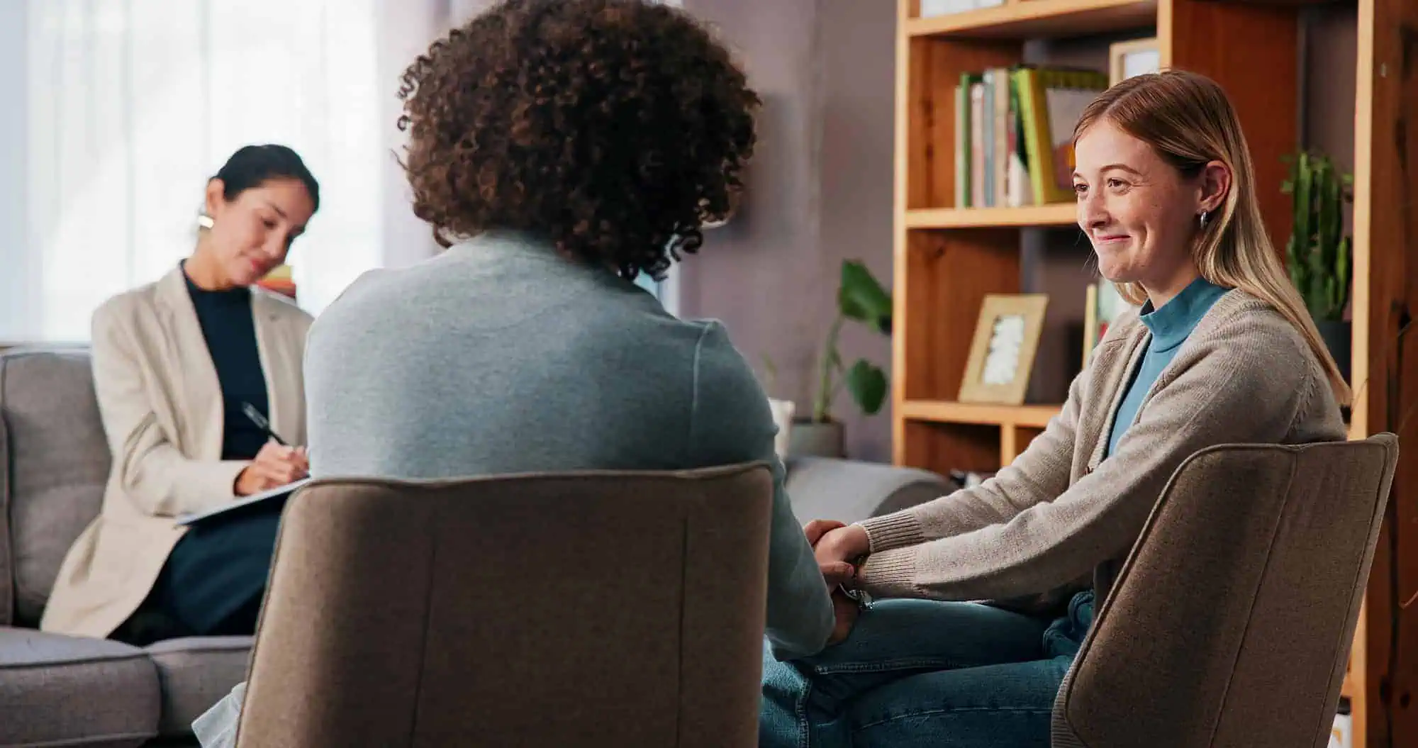 Three women in a supportive counseling session