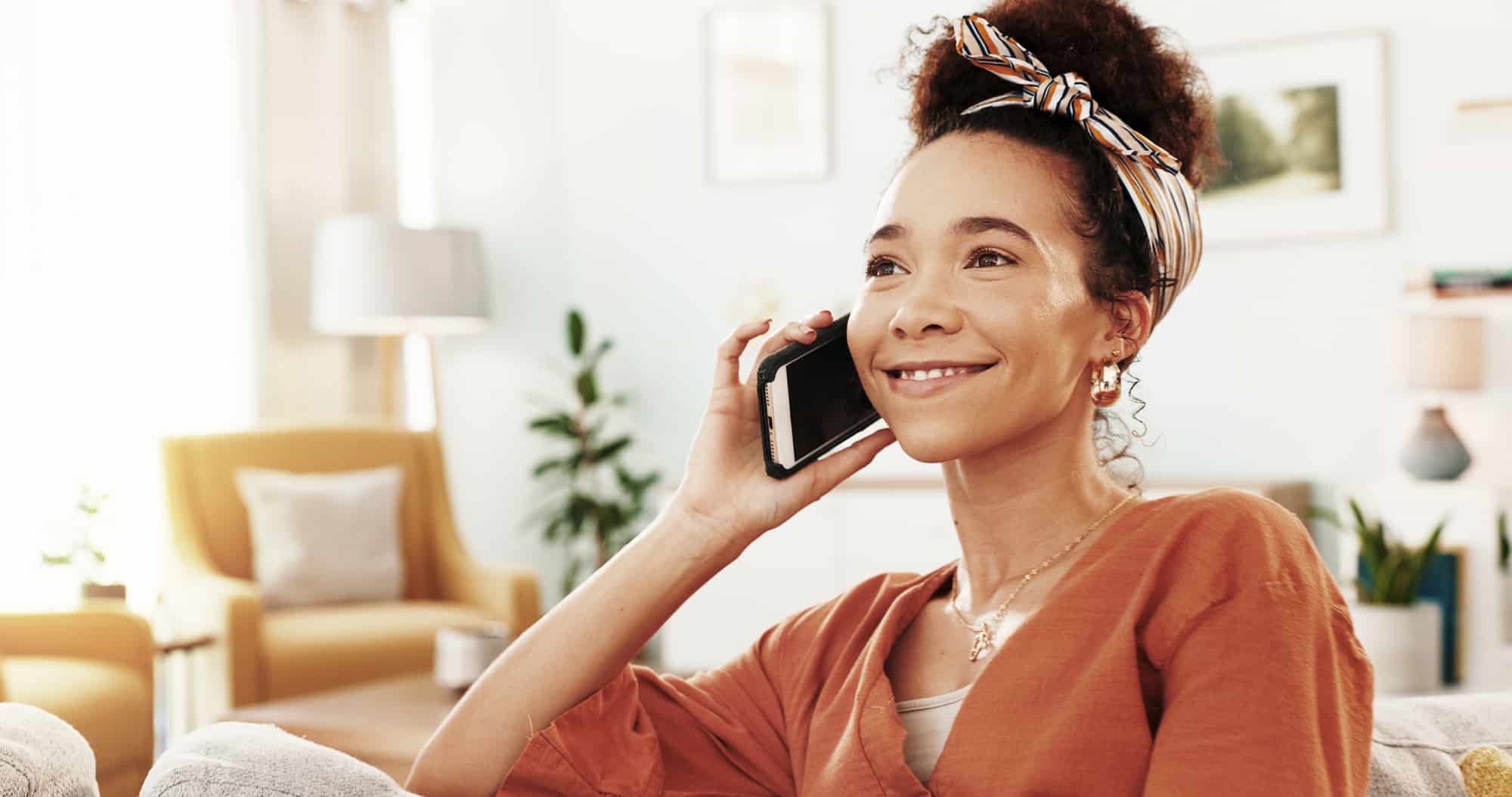 A woman on the phone chatting to treatment centre about her out-of-network mental health benefits