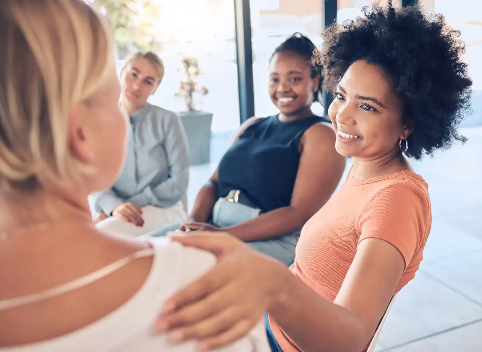 A small group of women supporting each other during a women-only group therapy session